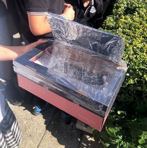 Solar ovens made from shoe boxes, tinfoil, black paper and gladwrap.
