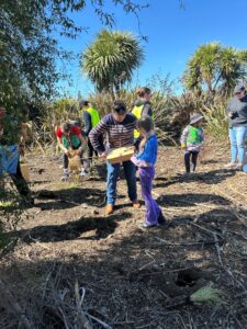 The Mayor helping put on plant guards